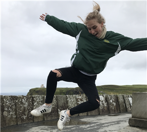 This photo is Ms. Lowney jumping in the air on the Cliffs of Moher in Ireland